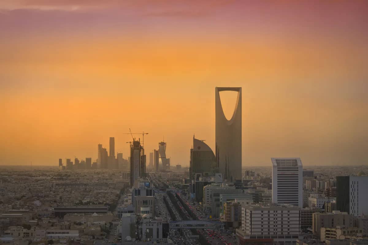 Riyadh skyline with the King Abdullah Financial District and Kingdom Tower in warm evening haze